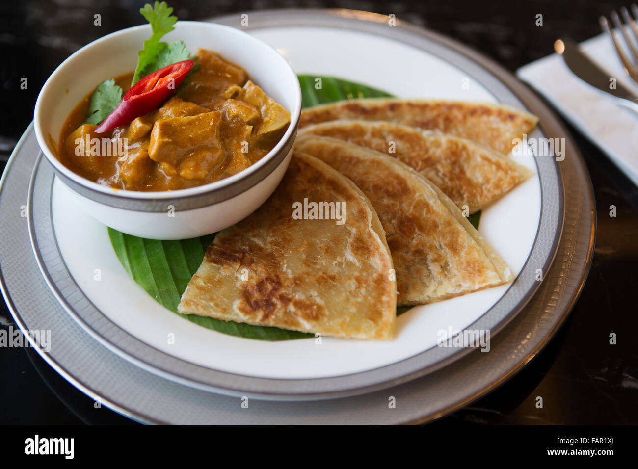 Chicken curry served with paratha in Yangon, Myanmar (Burma Stock Photo