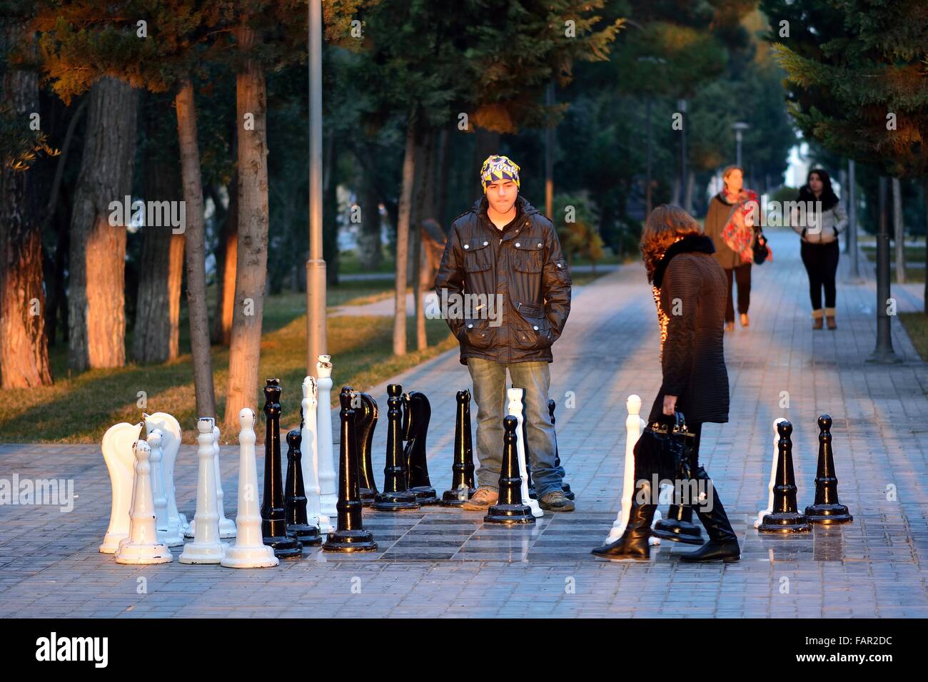 SUMGAIT, AZERBAIJAN - JANUARY 17 2014  A couple play a game of street chess in a park in central Sumgait, around 30km from Baku Stock Photo
