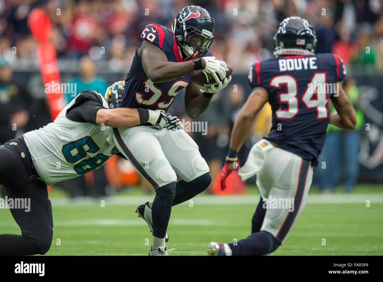 Houston, Texas, USA. 3rd Jan, 2016. Houston Texans outside linebacker Whitney Mercilus (59) recovers a fumble during the 4th quarter of an NFL game between the Houston Texans and the Jacksonville Jaguars at NRG Stadium in Houston, TX on January 3rd, 2016. Credit:  Trask Smith/ZUMA Wire/Alamy Live News Stock Photo
