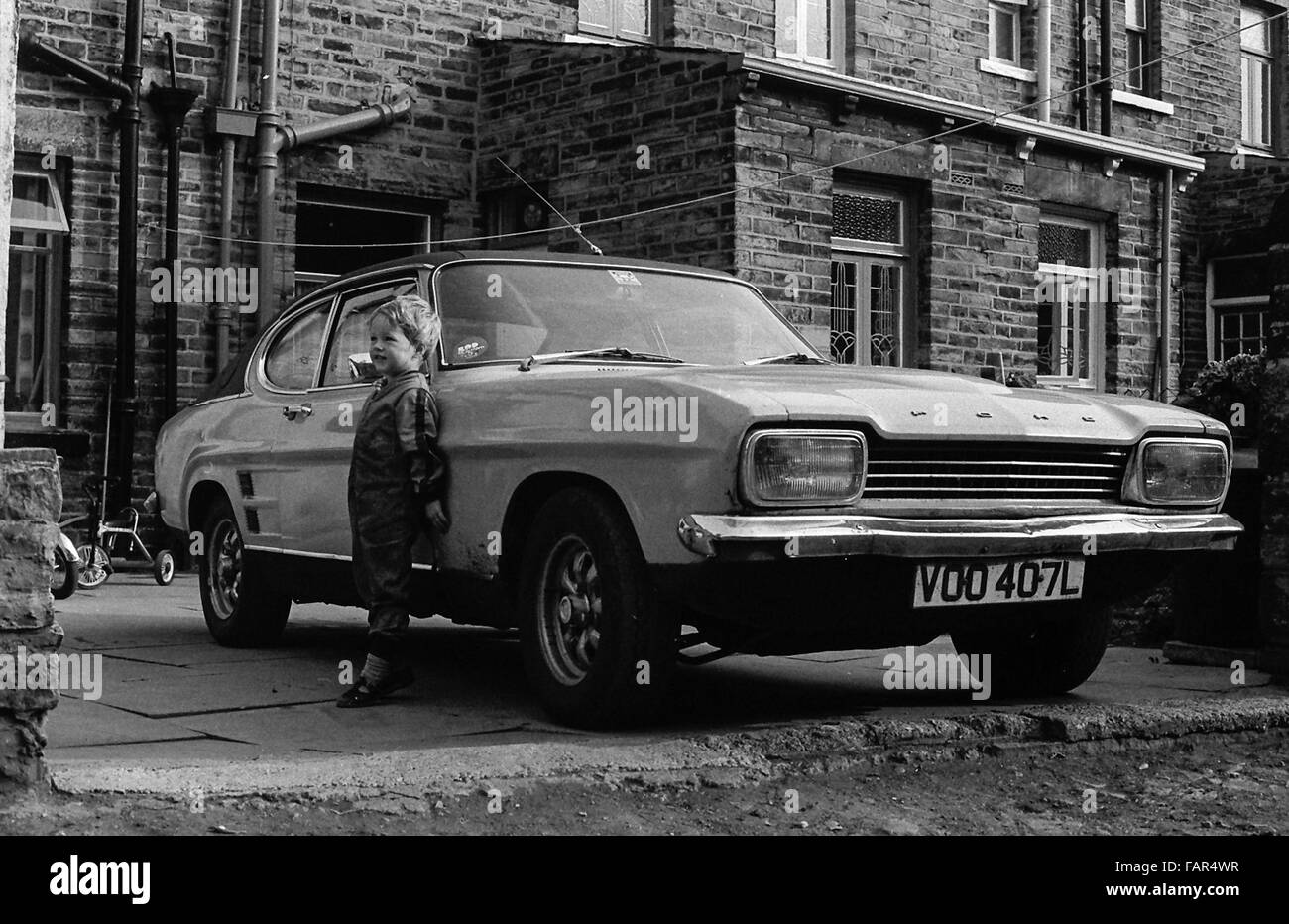 North of England 1982, young boy standing next to Ford Capri. Stock Photo