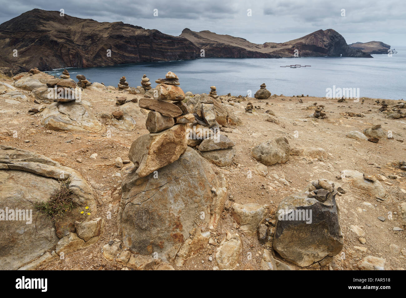 Madeira - Ponta do Buraco. Erratic stones on the bare landscape are piled into balanced towers by visitors. Stock Photo
