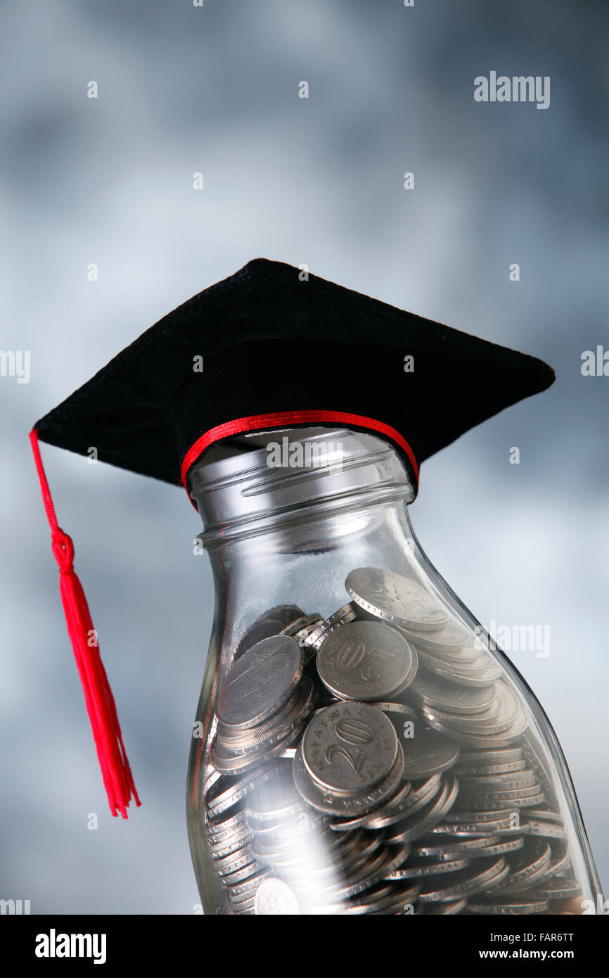 Bottle of cash with graduation cap Stock Photo Alamy