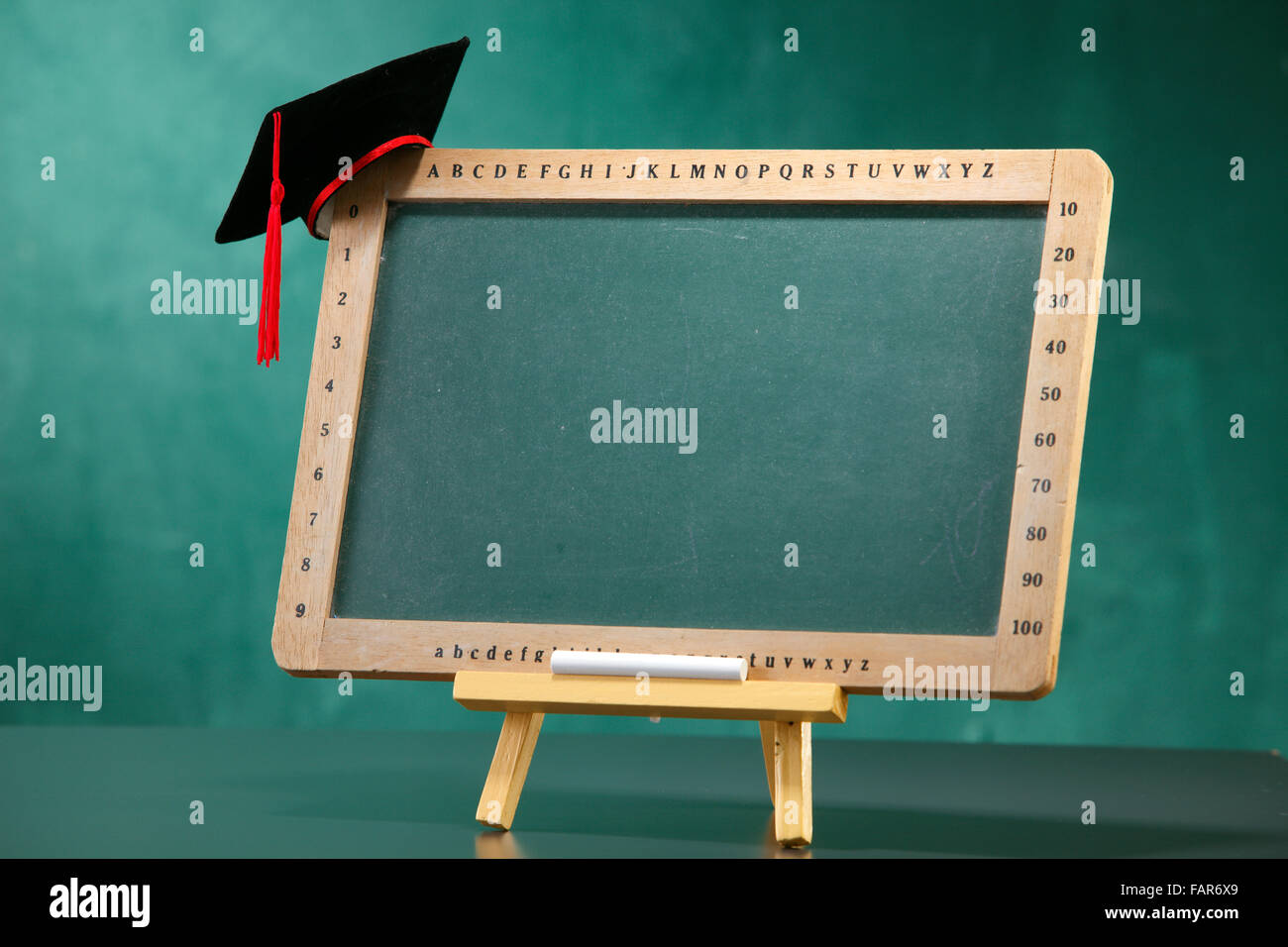 Graduation hat on the blackboard. Stock Photo