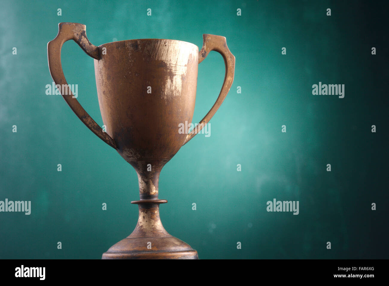 Trophy cup isolated on the green background Stock Photo - Alamy