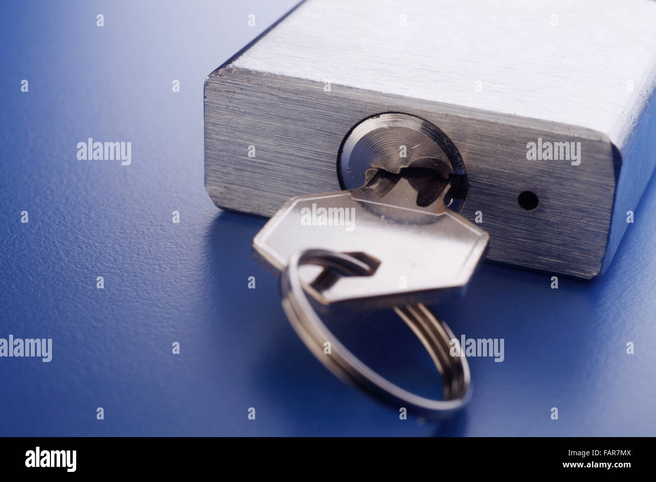 Padlock with key isolated on background Stock Photo - Alamy