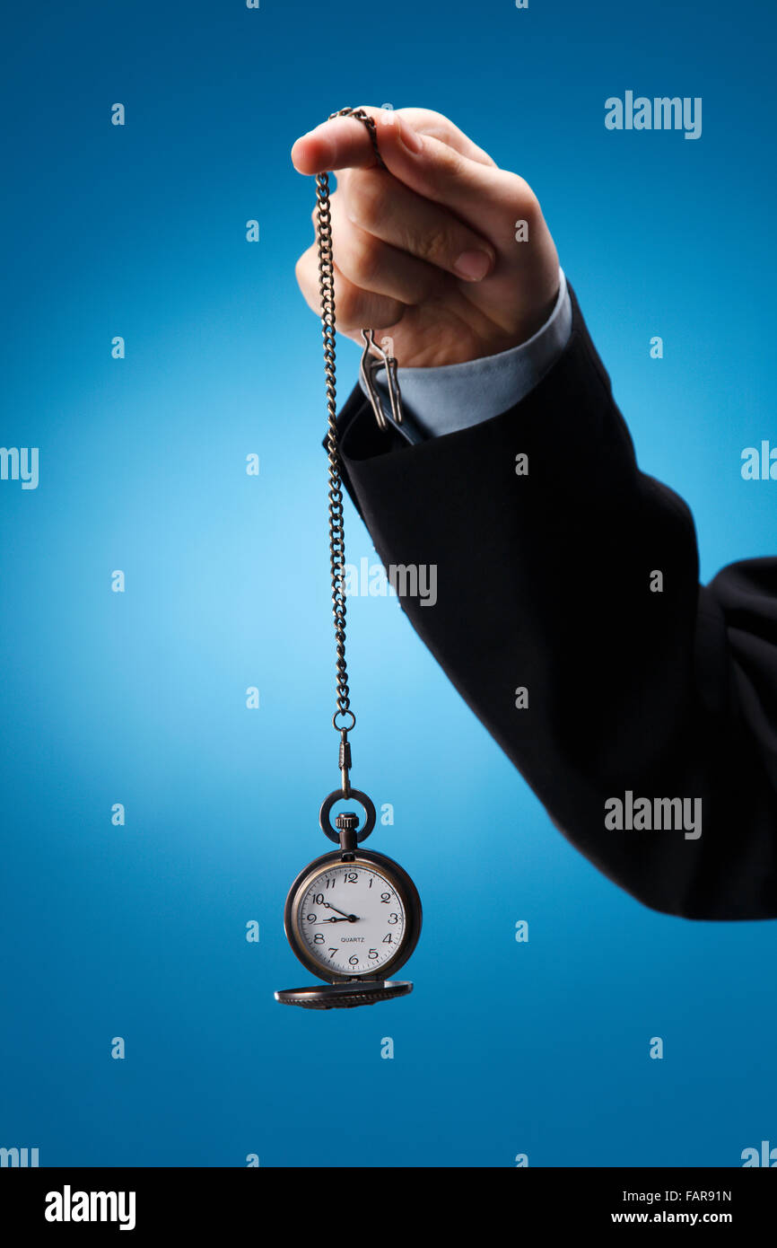Human hand swinging a pocketwatch Stock Photo Alamy
