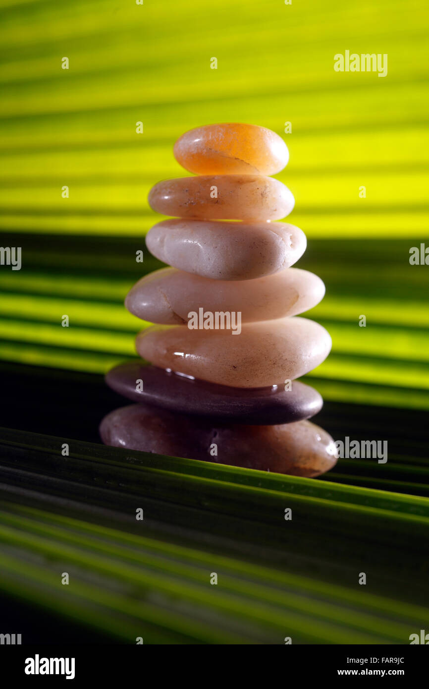Stack of stones on the green leaf Stock Photo - Alamy