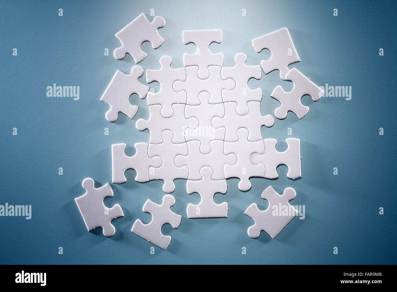 Puzzle pieces isolated on the blue background Stock Photo - Alamy