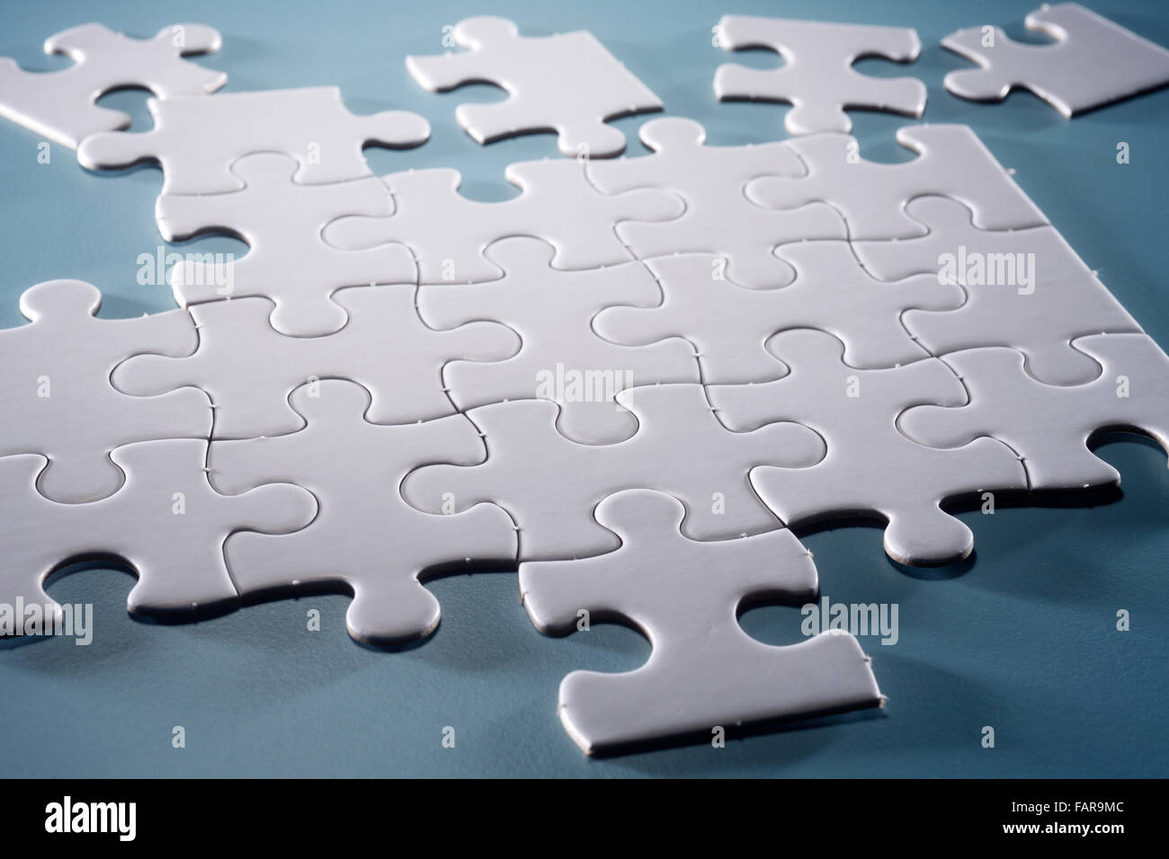 Puzzle pieces isolated on the blue background Stock Photo - Alamy