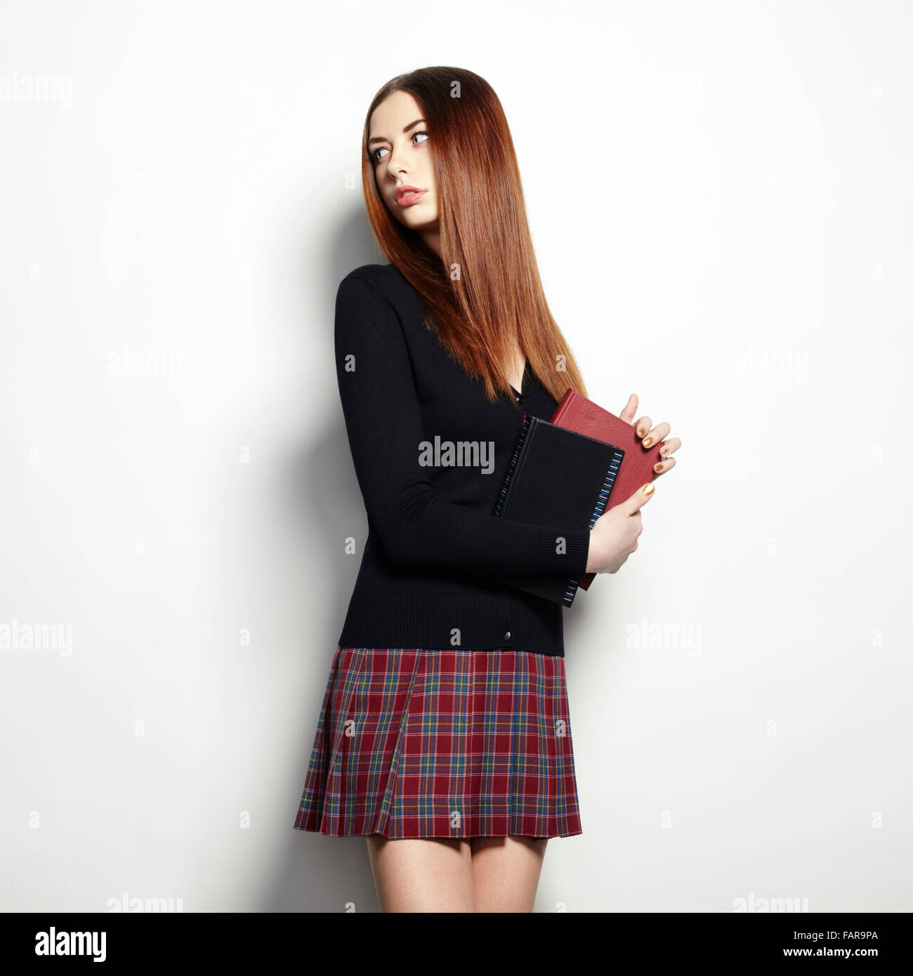 Portrait of young beautiful girl with books Stock Photo - Alamy