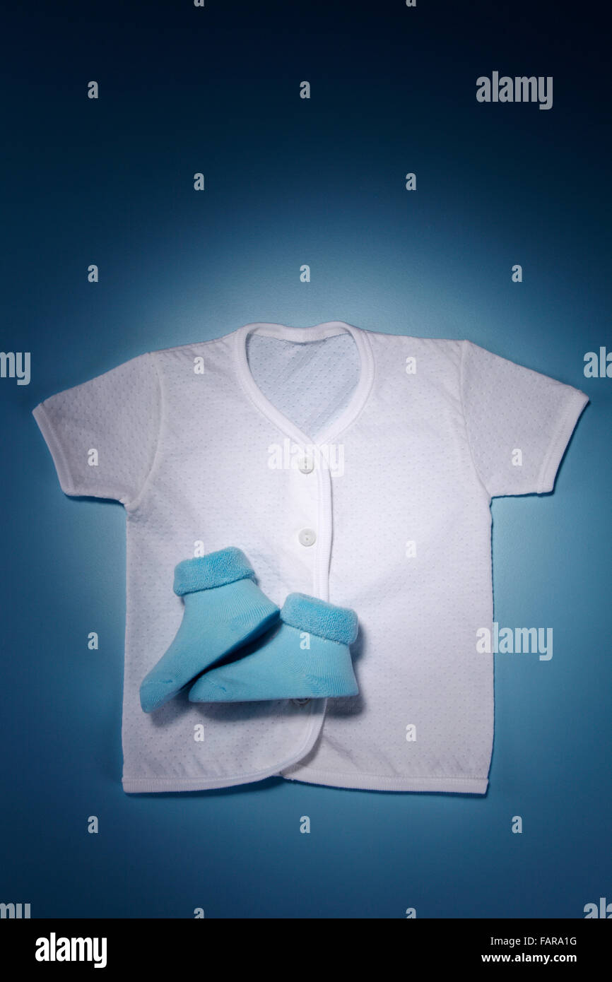 Shirt with blue boots isolated on blue background. Stock Photo