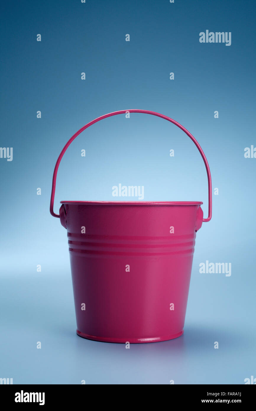 pink bucket isolated on the blue background. Stock Photo