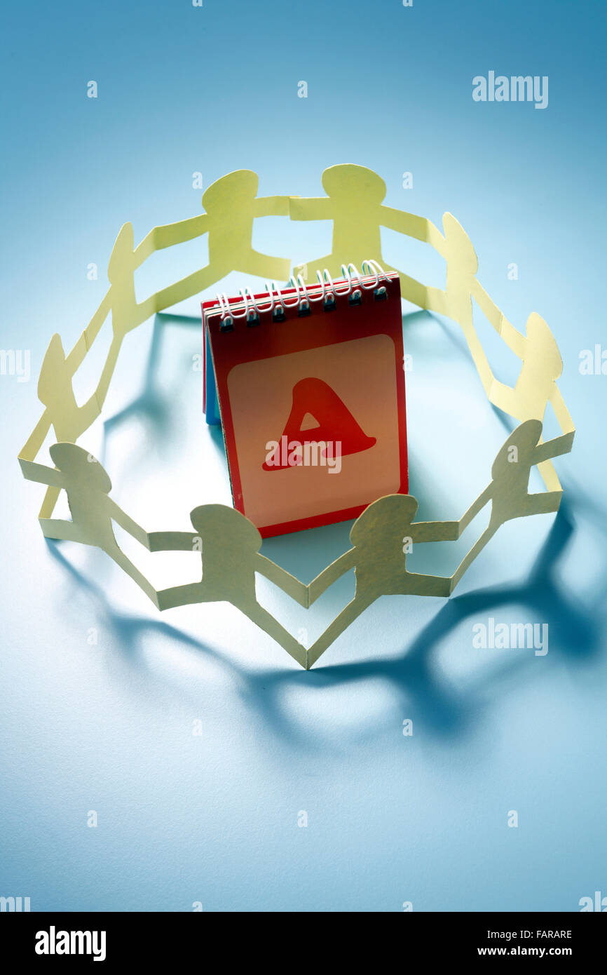 Paper chain surrounding a notebook Stock Photo - Alamy
