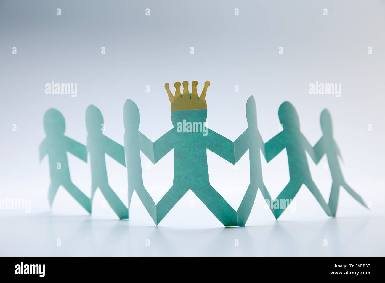 Paper chain holding hands together Stock Photo - Alamy