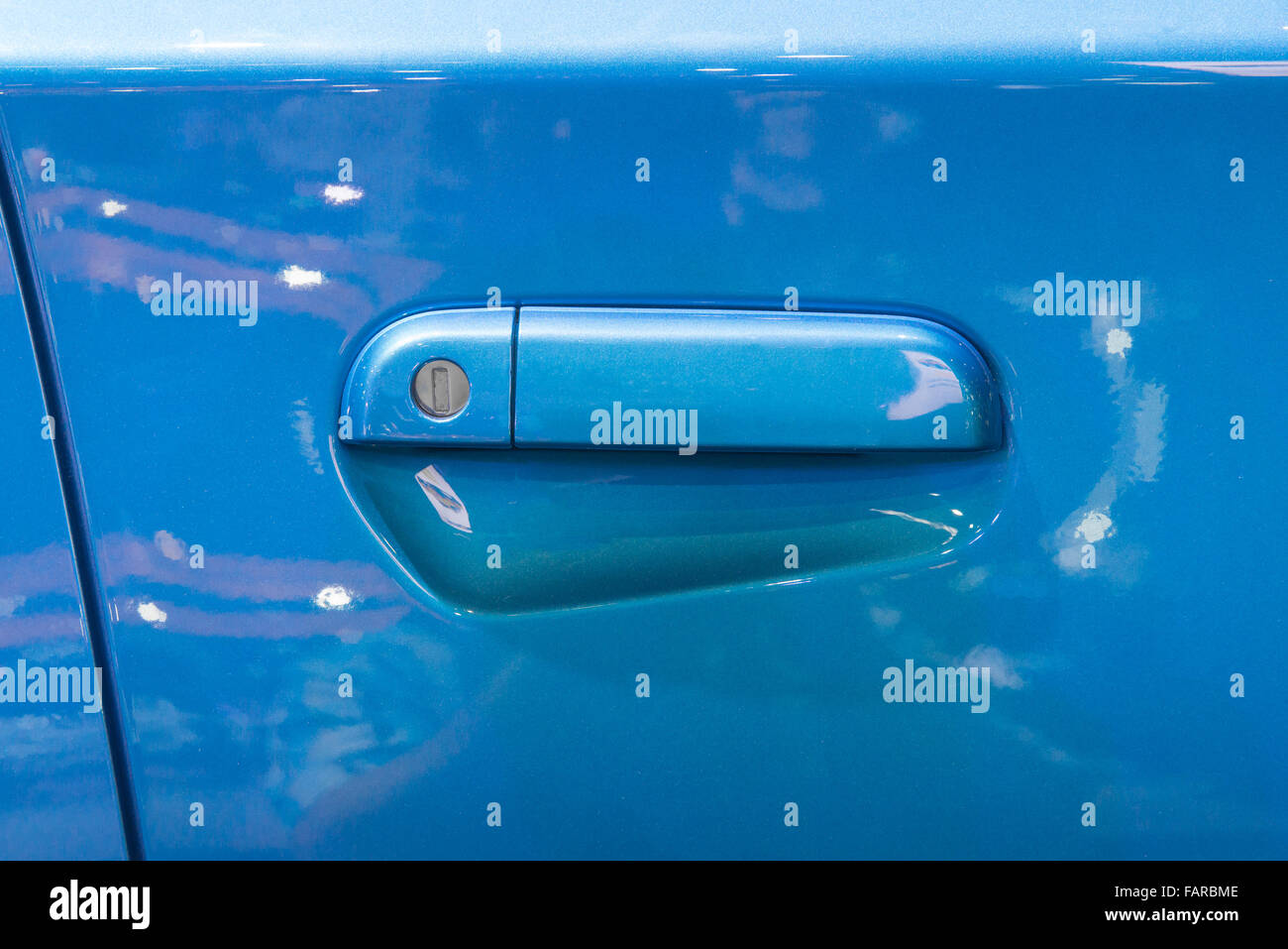 Door handle on a white car door coated with a 2-component heavy-duty  protective paint for extreme conditions, raptor paint Stock Photo - Alamy