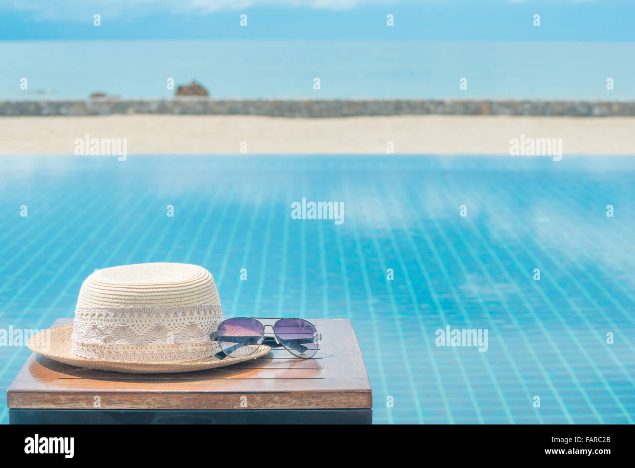 Hat and sunglasses at the sea background Stock Photo