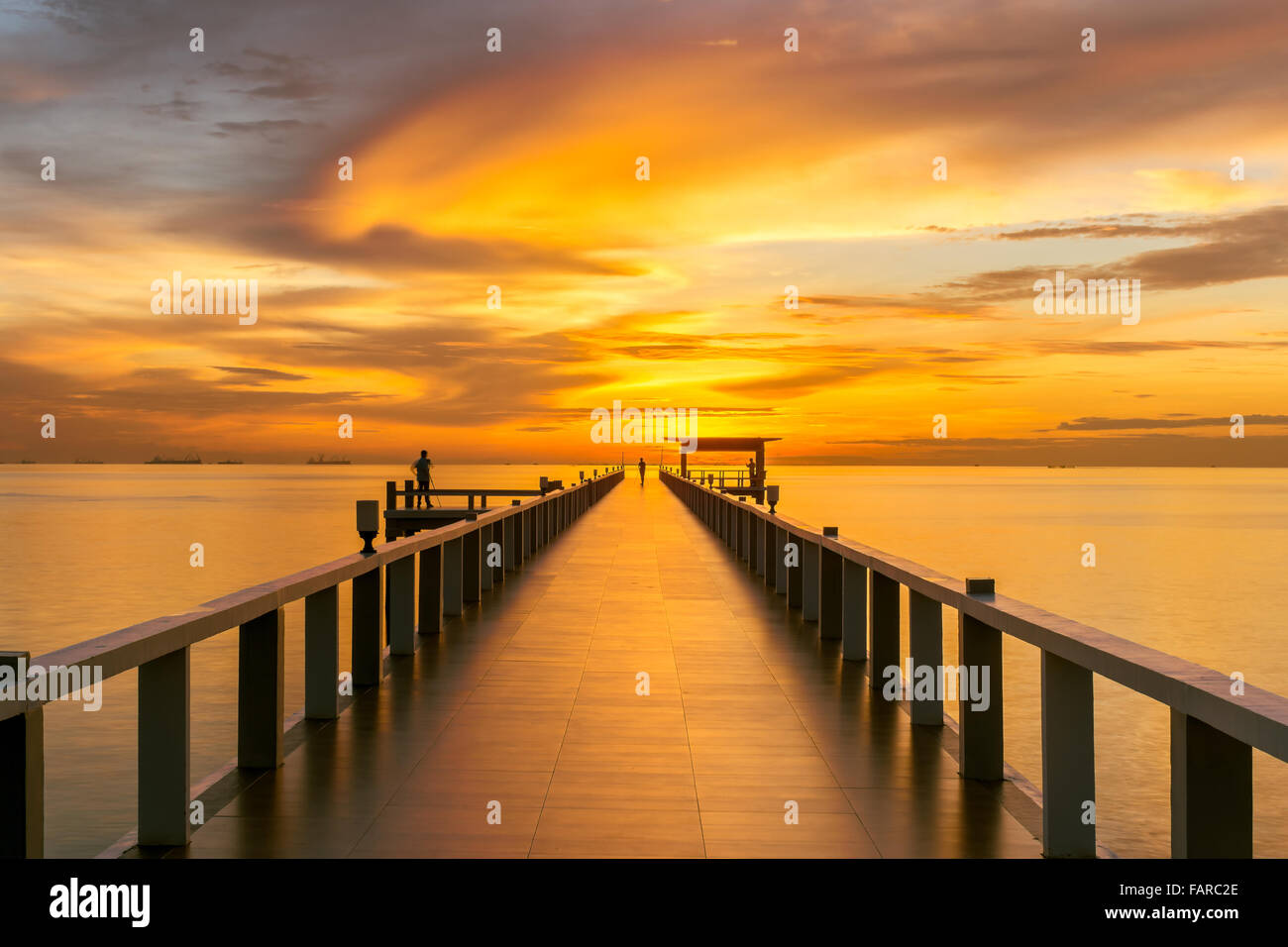 Summer, Travel, Vacation and Holiday concept - Wooden pier between sunset in Phuket, Thailand Stock Photo