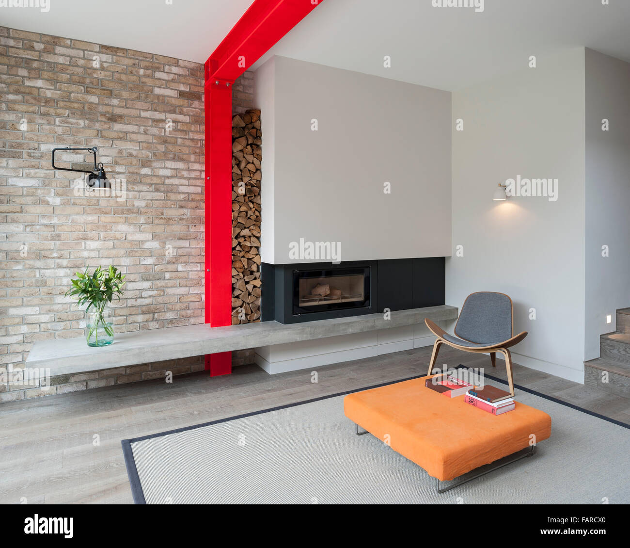 View Towards Fireplace And Concrete Plinth With Stacked Logs