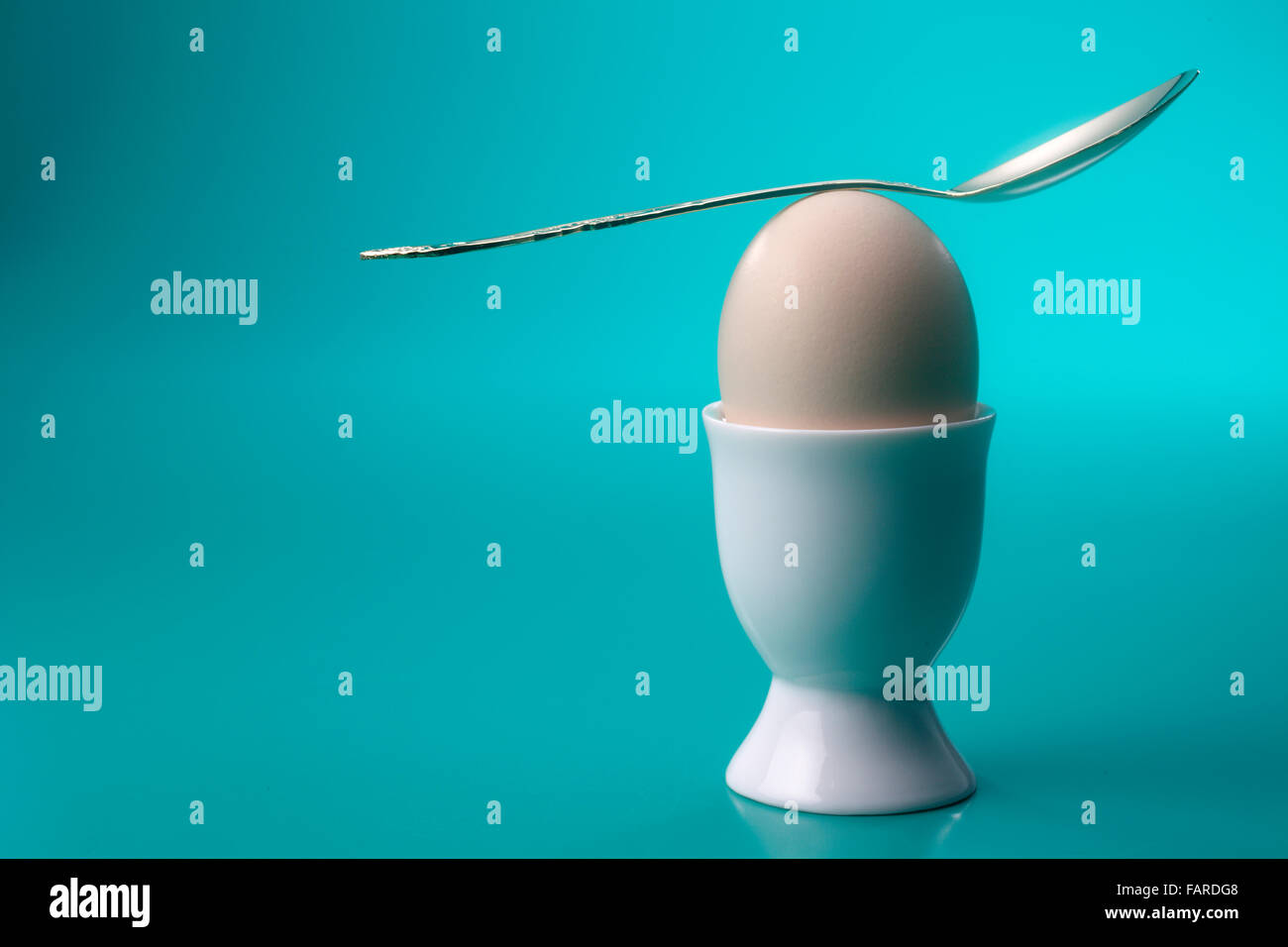 spoon welll balance on top of egg Stock Photo - Alamy
