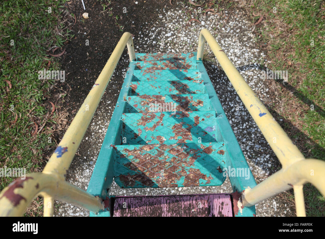 rusty staircase of a slide at an abandoned playgorund Stock Photo