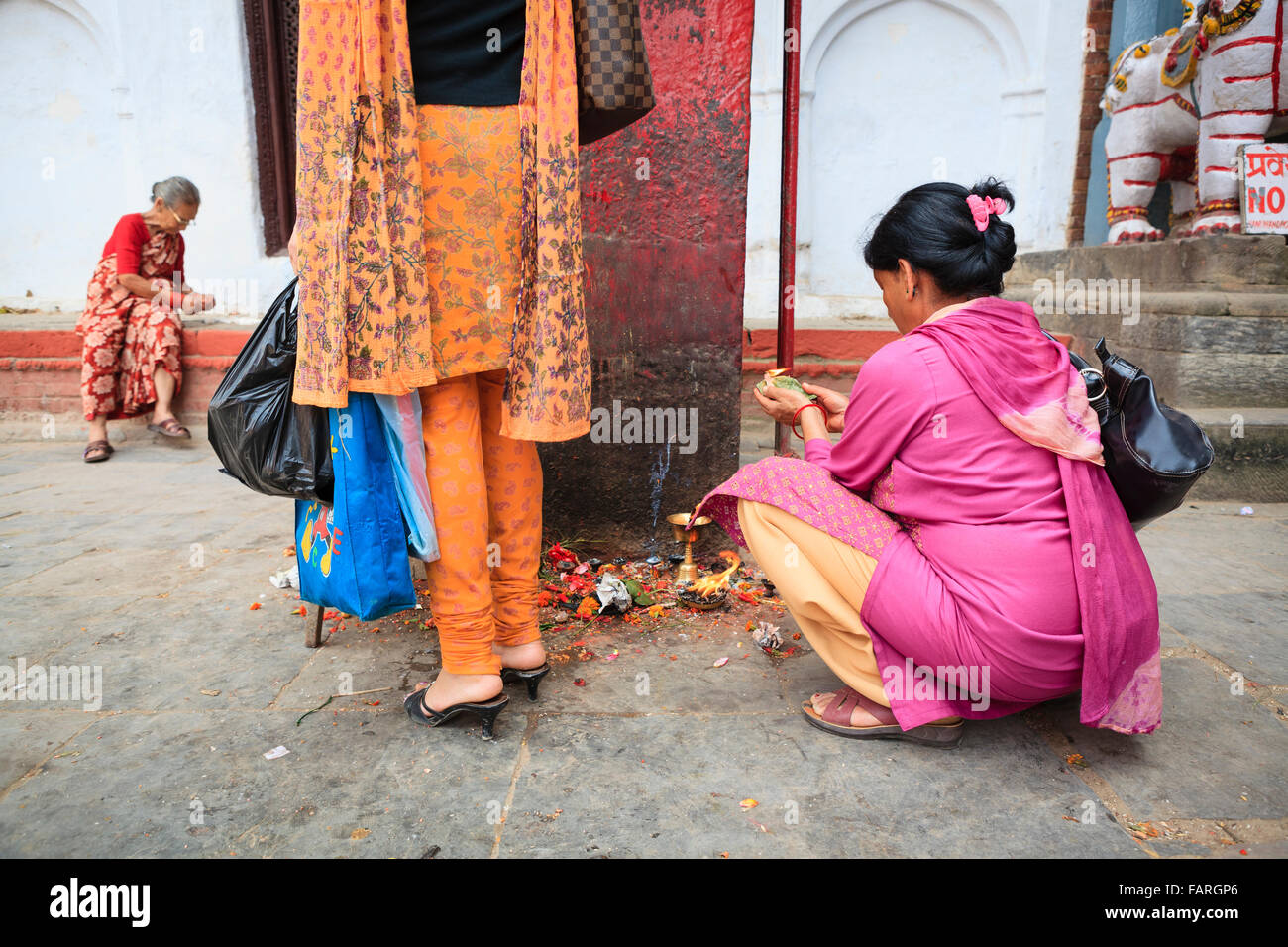 Women making offerings at Durbar Square. Kathmandu. Nepal. Stock Photo