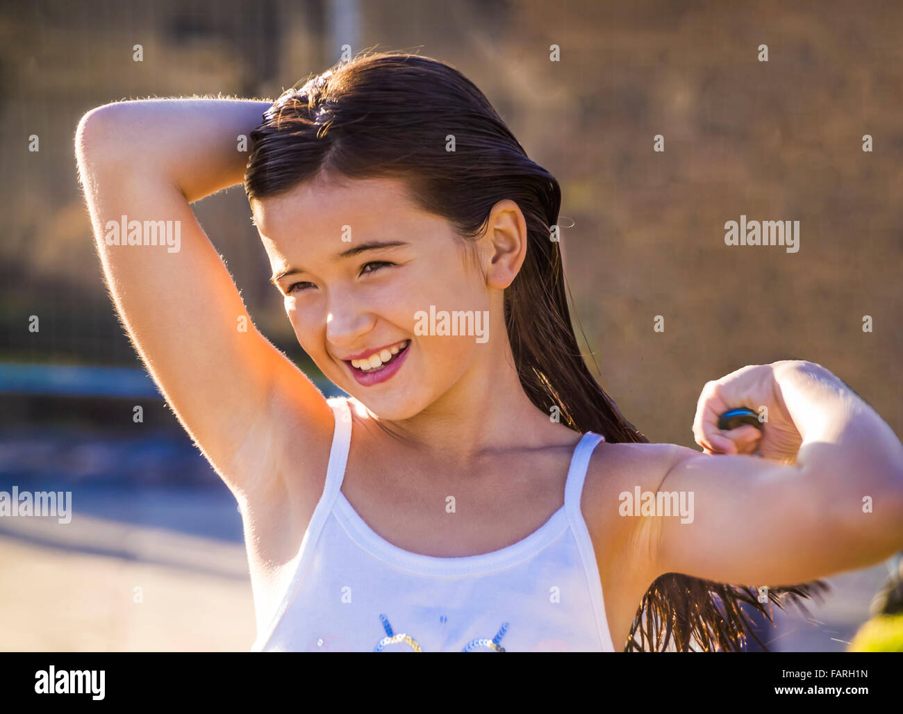 Young girl at the beach brushing her wet hair after swimming, St Kilda