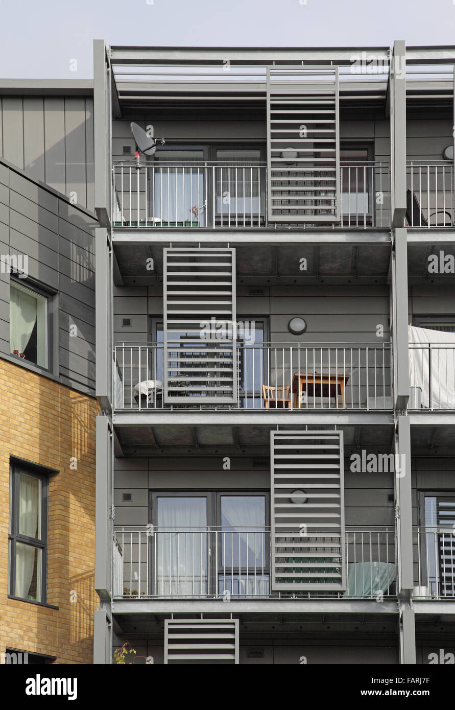 Steel balconies on a 5 storey residential block in Hackney, London.Shows structural steel frame, steel louvres and zinc cladding Stock Photo