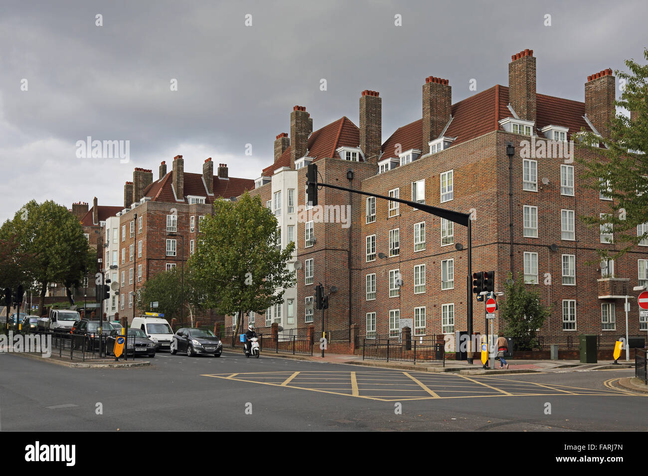 Local Authority 1930s tenement blocks on Dog Kennel Hill in South London. Large, traffic light controlled junction in foreground Stock Photo