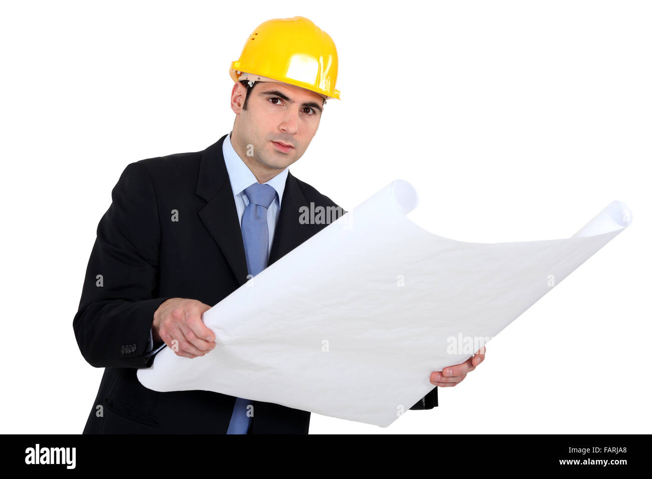 Engineer studying plans Stock Photo