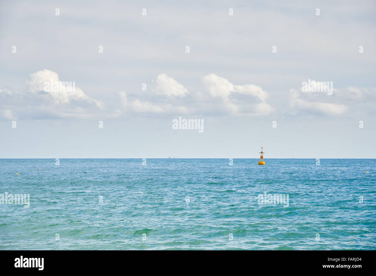 Horizontal seascape with buoy mark and dynamic clouds, view from Haeundae beach in Busan, Korea. Stock Photo