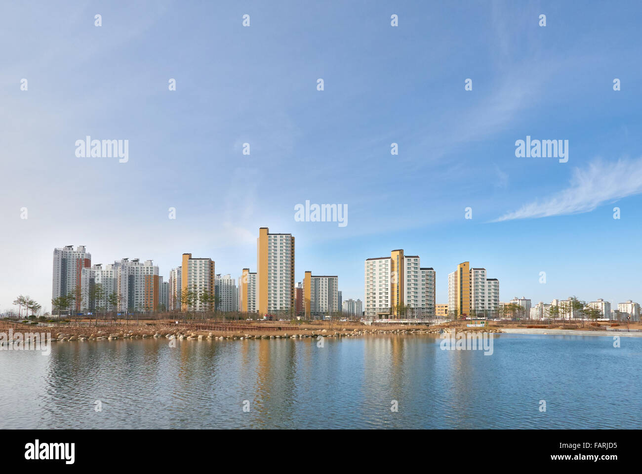 residential buildings and clear lake in a sunny day Stock Photo