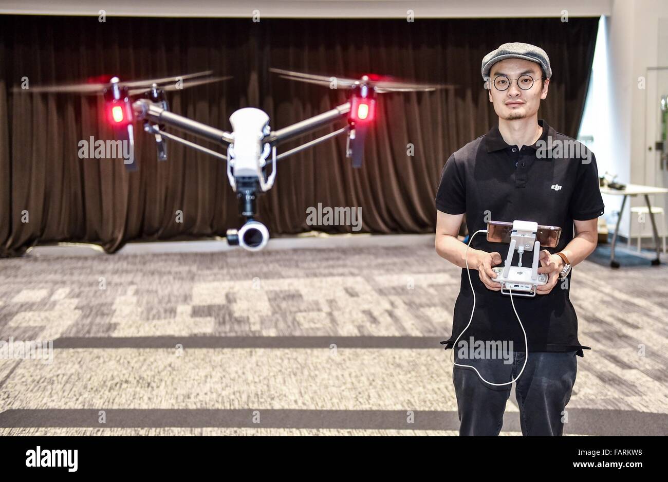 Beijing, China's Guangdong Province. 22nd May, 2015. Wang Tao, founder of Da-Jiang Innovations (DJI), controls a drone in his company in Shenzhen, south China's Guangdong Province, May 22, 2015. 2015 is the dawn of the drone age. Drone is no longer a high-tech military equipment, but also be used in photography, fire extinguishing, agricultural control and other private and commercial areas. © Mao Siqian/Xinhua/Alamy Live News Stock Photo