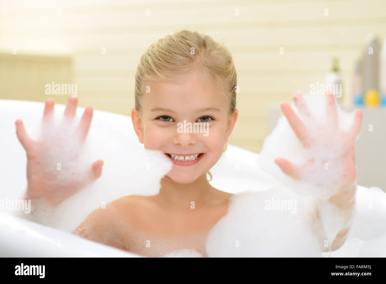 Pleasant little girl playing in bath tube Stock Photo Alamy