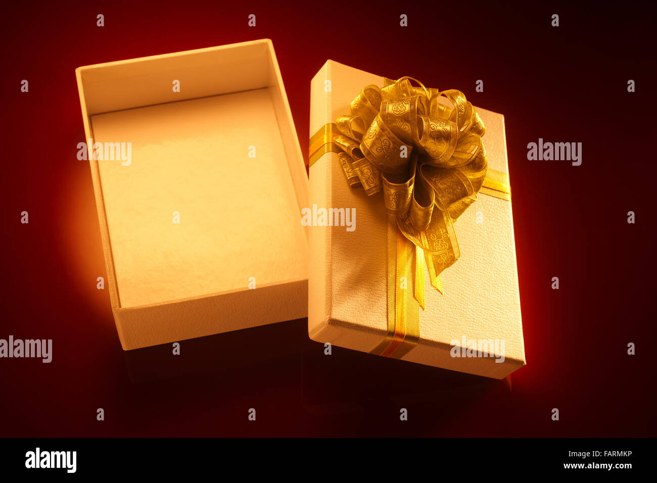 Isolated open gift box with gold ribbon Stock Photo