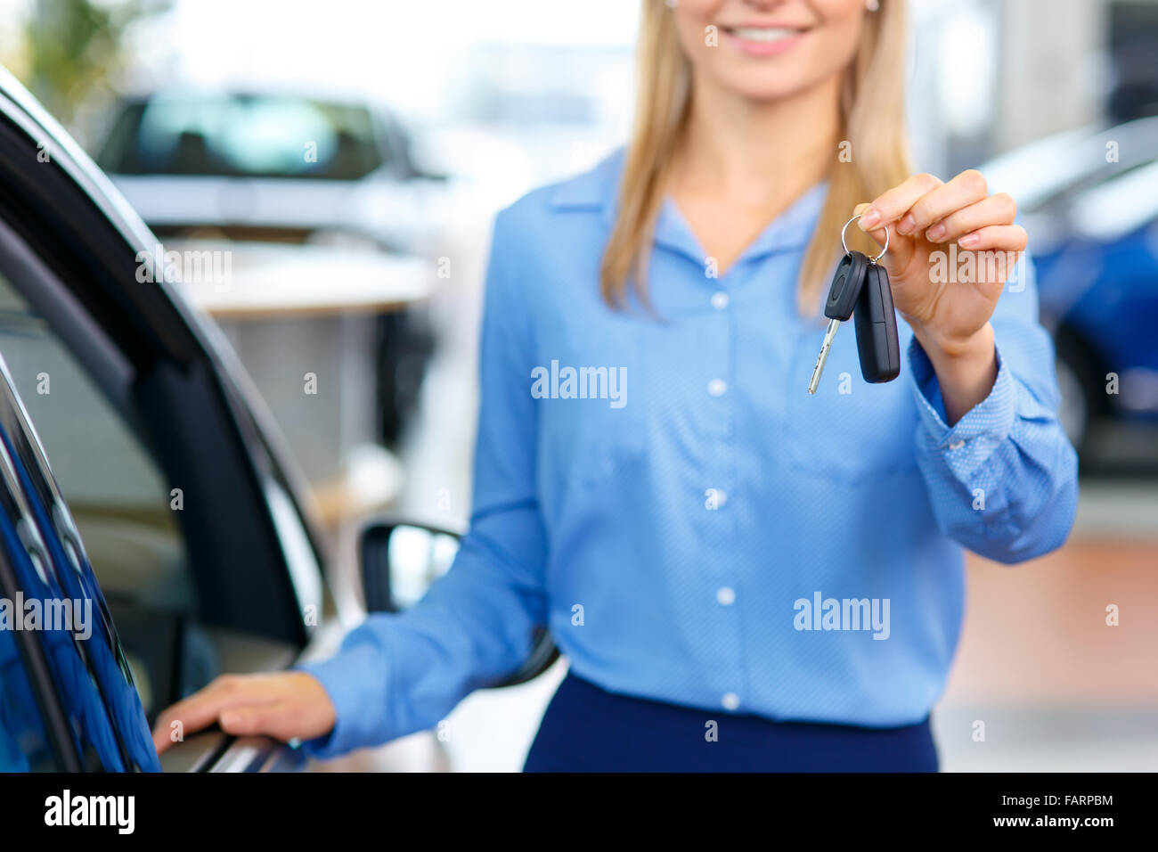 Sale assistant showing the car Stock Photo Alamy