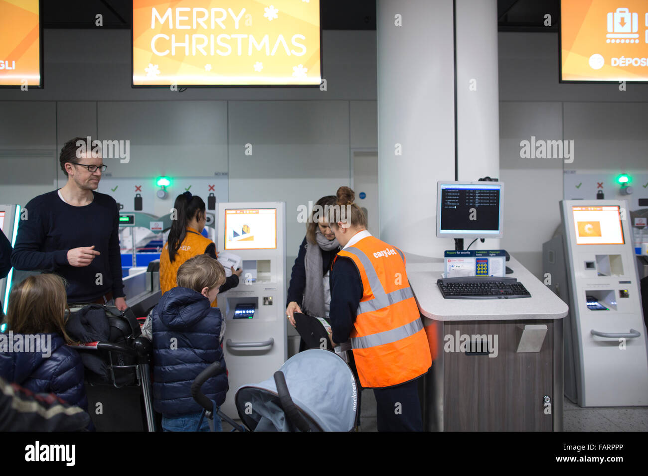 Christmas holiday makers check in at the easyJet bag drop facilities, Gatwick airport North terminal, England, UK Stock Photo