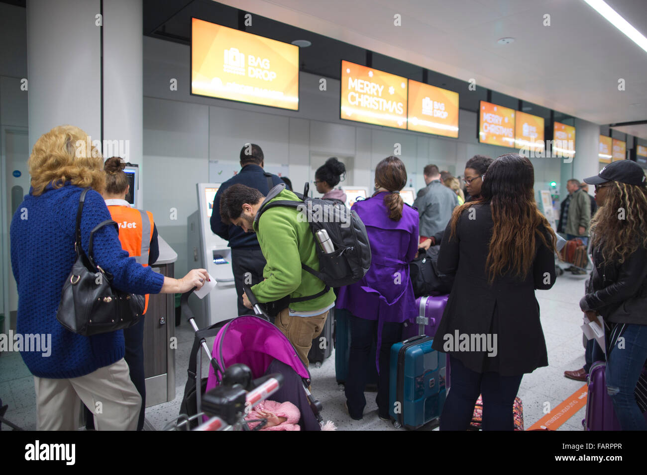 Christmas holiday makers check in at the easyJet bag drop facilities, Gatwick airport North terminal, England, UK Stock Photo