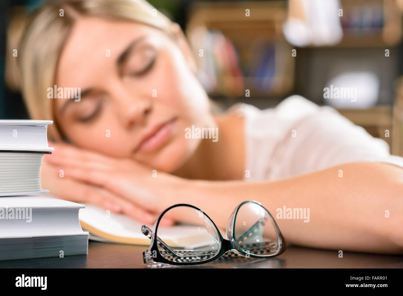 Young girl is asleep on the desk Stock Photo - Alamy