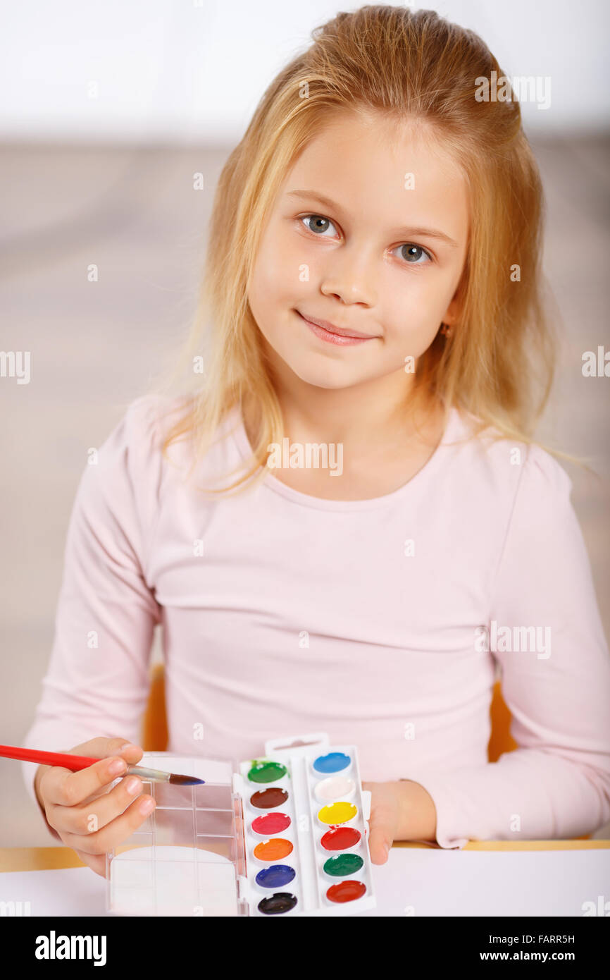 Little girl using watercolor paint Stock Photo Alamy