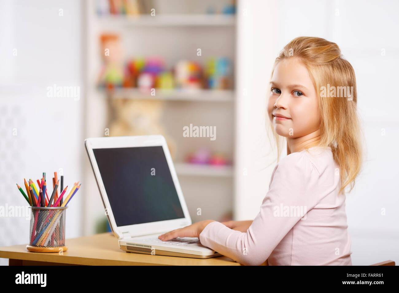 Little girl is using a laptop Stock Photo - Alamy