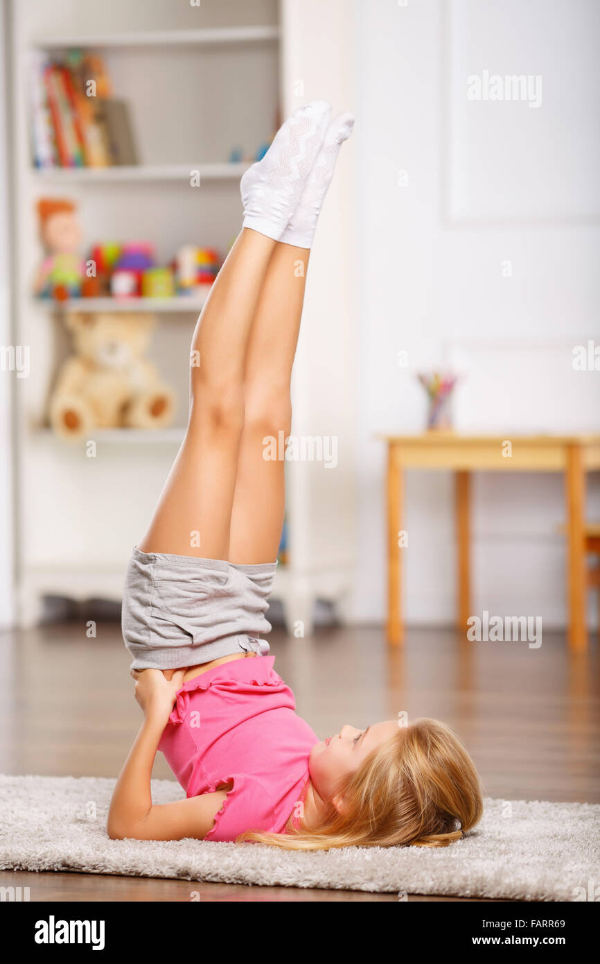 A good stretching regime. Cute gymnast practicing yoga or pilates. Little  girl doing split outdoor. Small child girl stretching legs muscle. Fit  child Stock Photo - Alamy