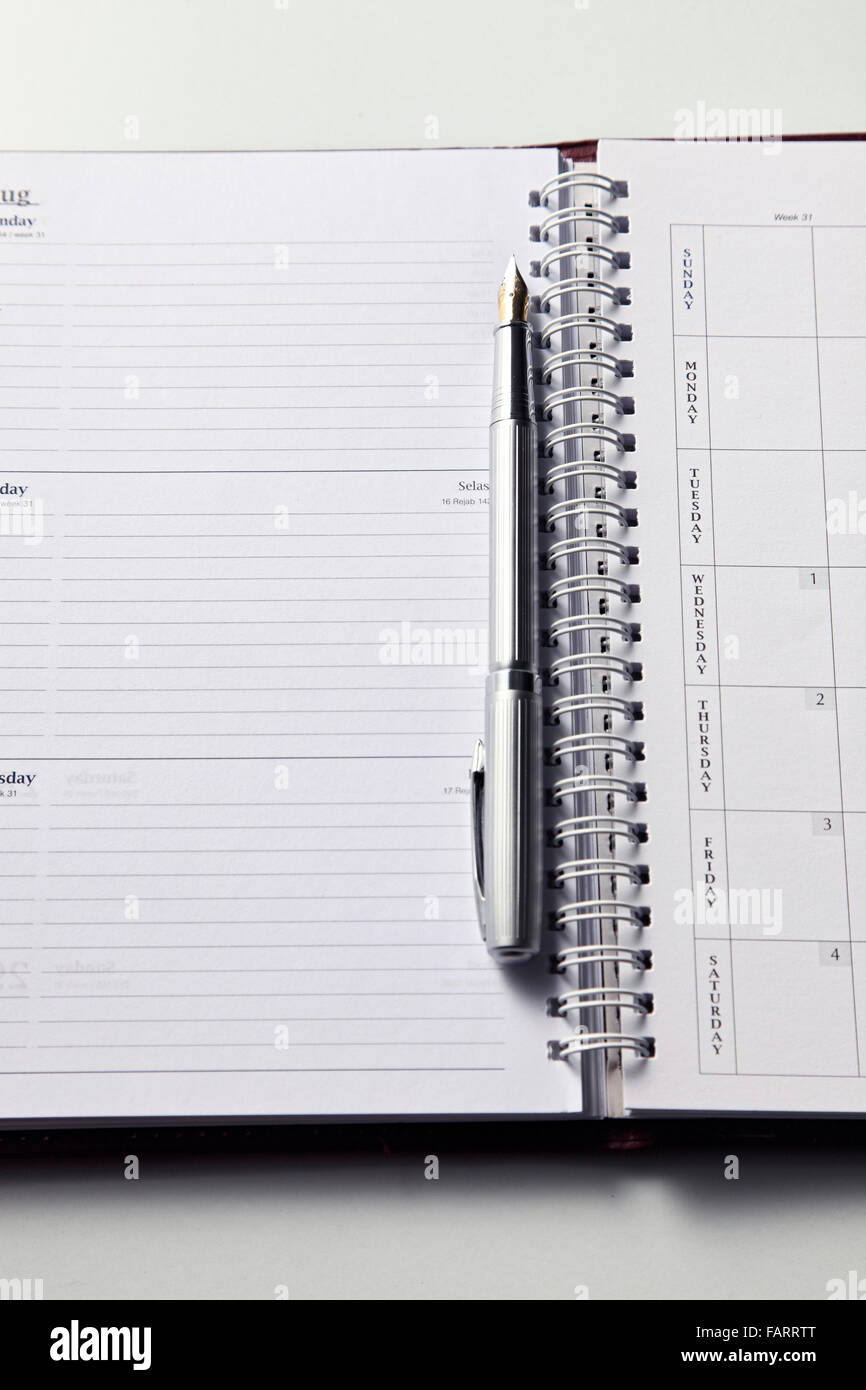 Close up of pen and blank organizer Stock Photo