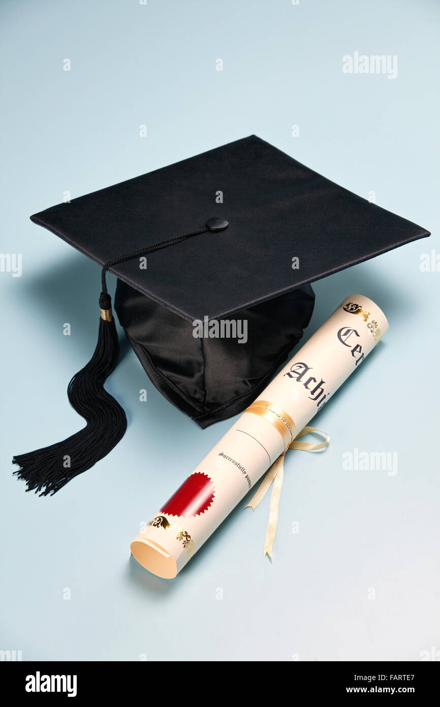 mortar board and the certificate on the plain background Stock Photo ...