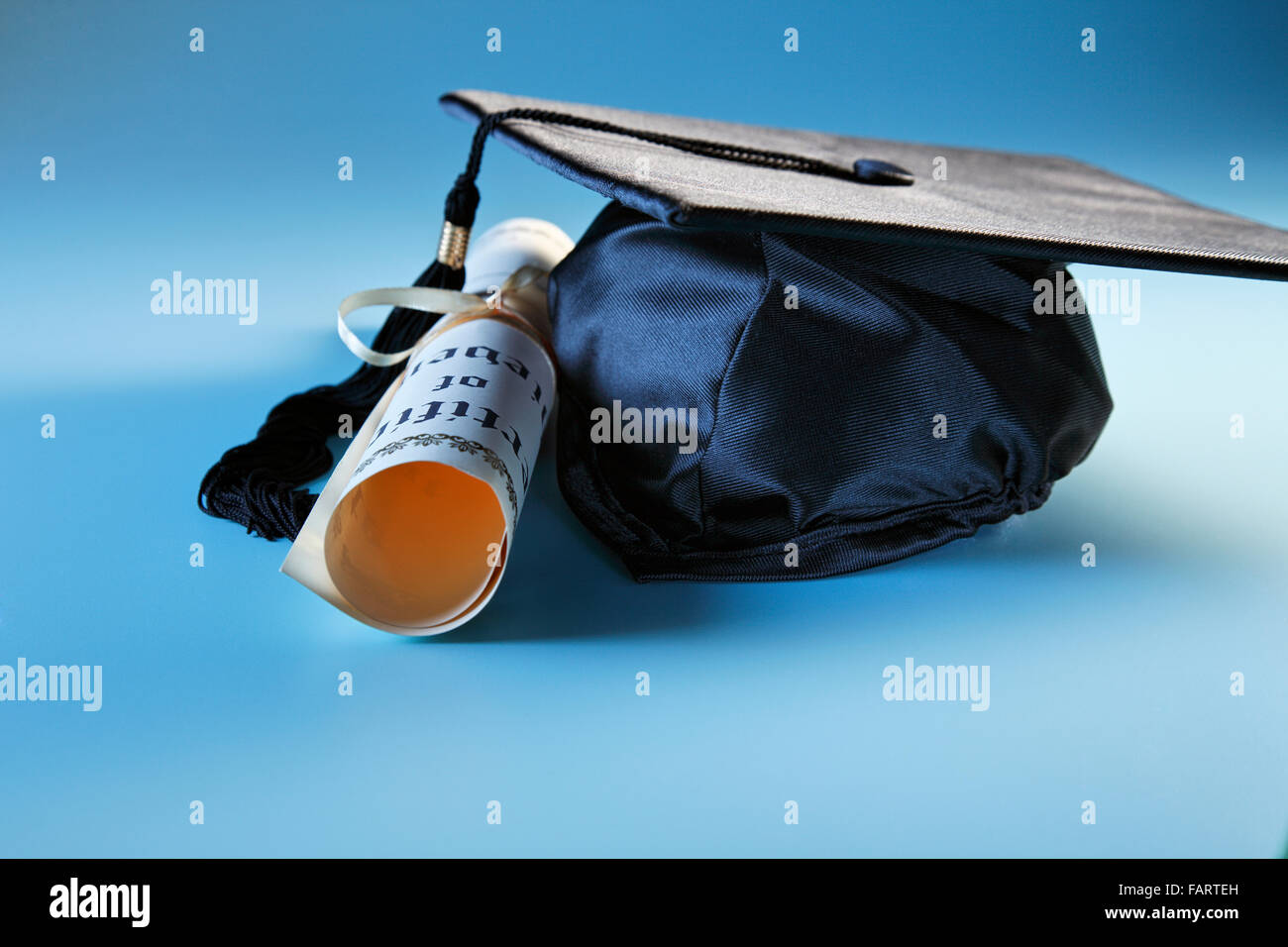 mortar board and the certificate on the plain background Stock Photo ...