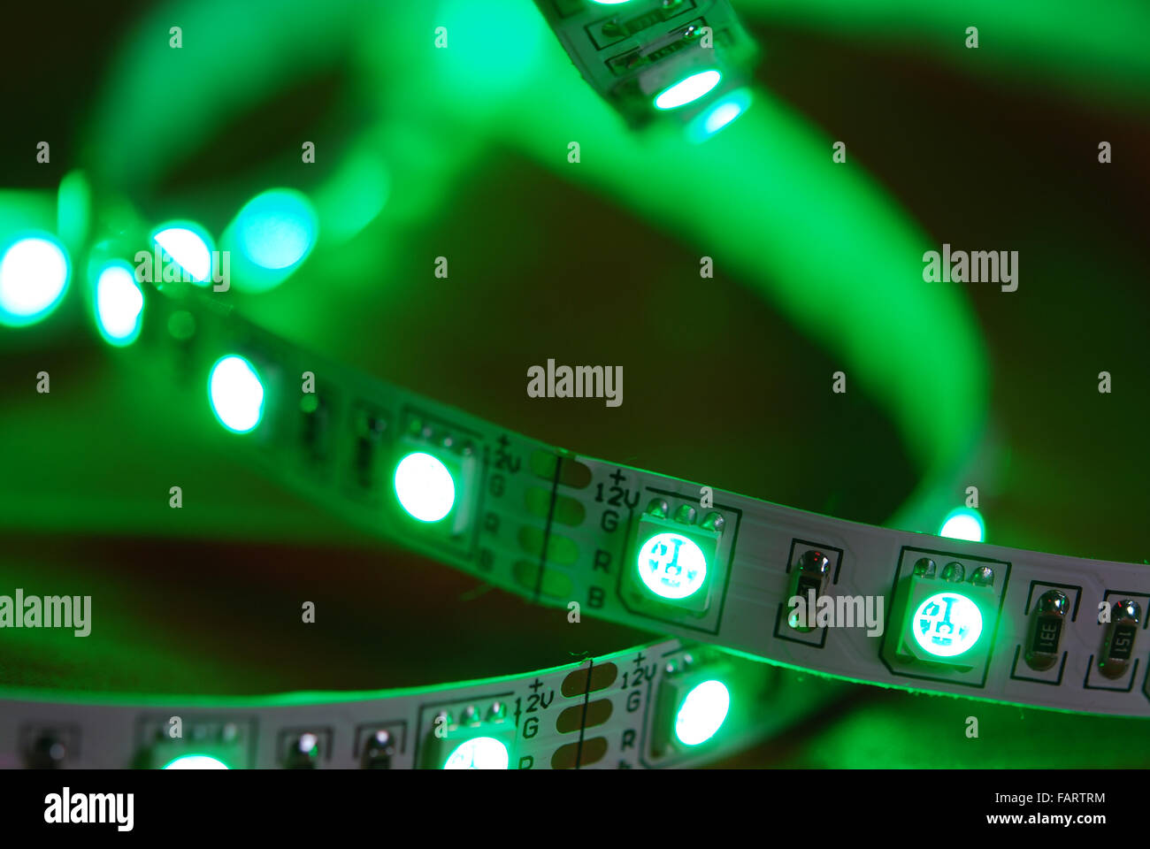 Green led strip on the background of red textile Stock Photo - Alamy