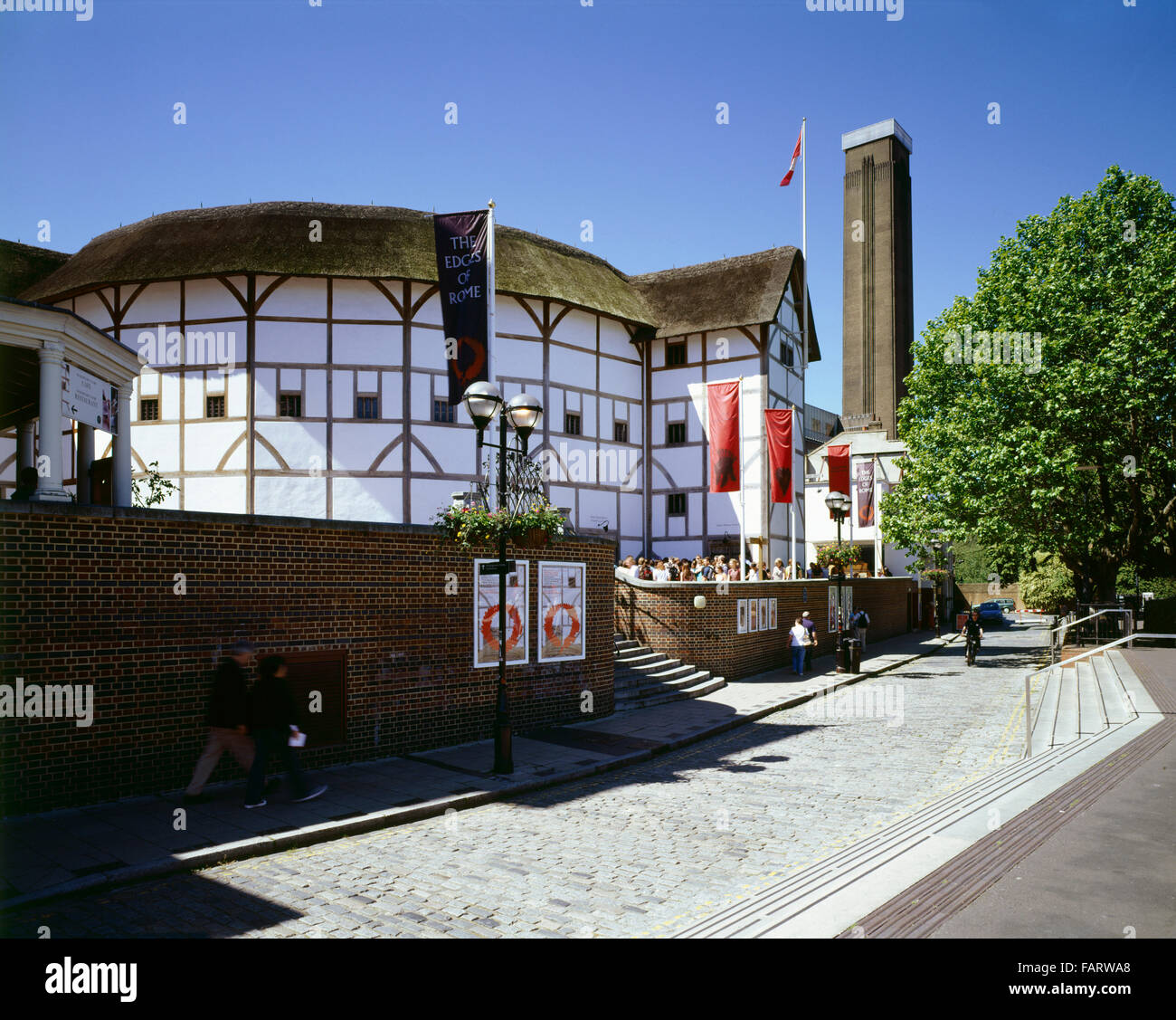 SHAKESPEARE'S GLOBE THEATRE, Bankside, London. General view of the theatre with the chimney of Tate Modern beyond. Stock Photo