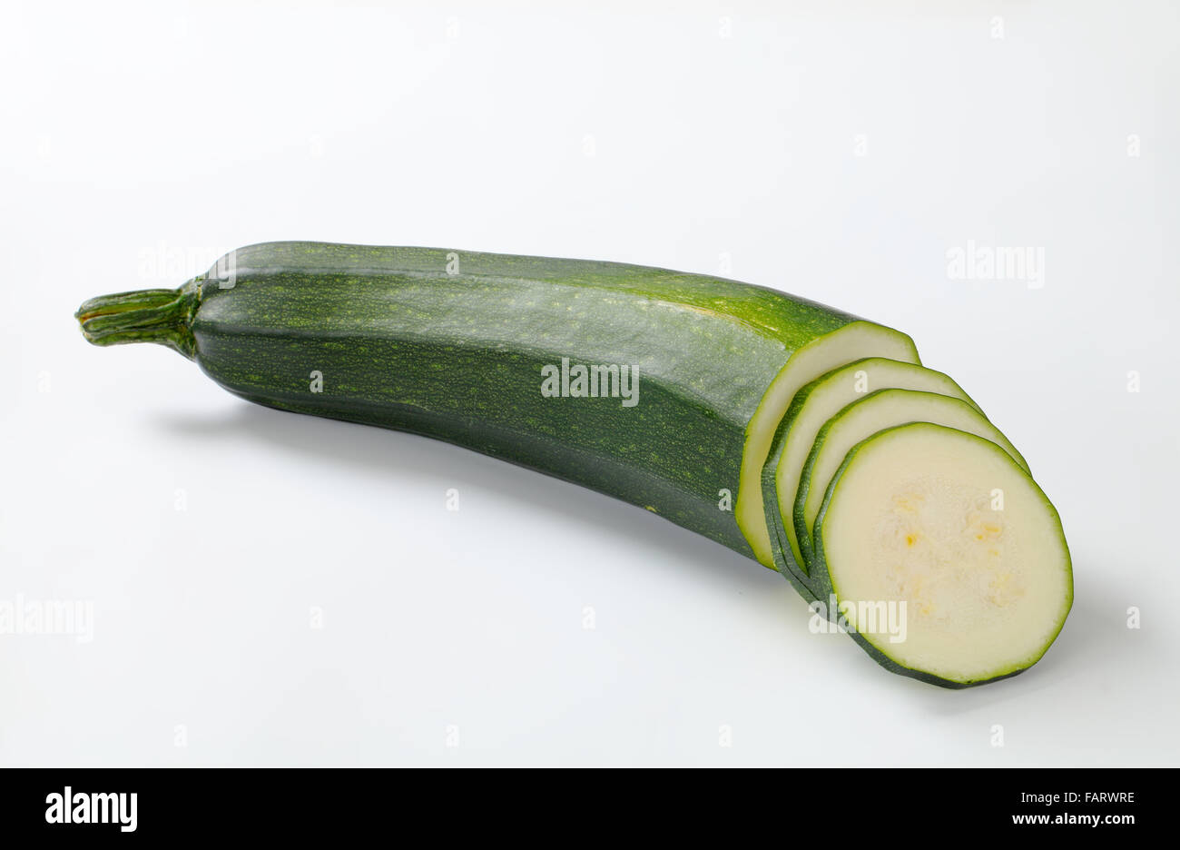 sliced fresh zucchini on a white background Stock Photo