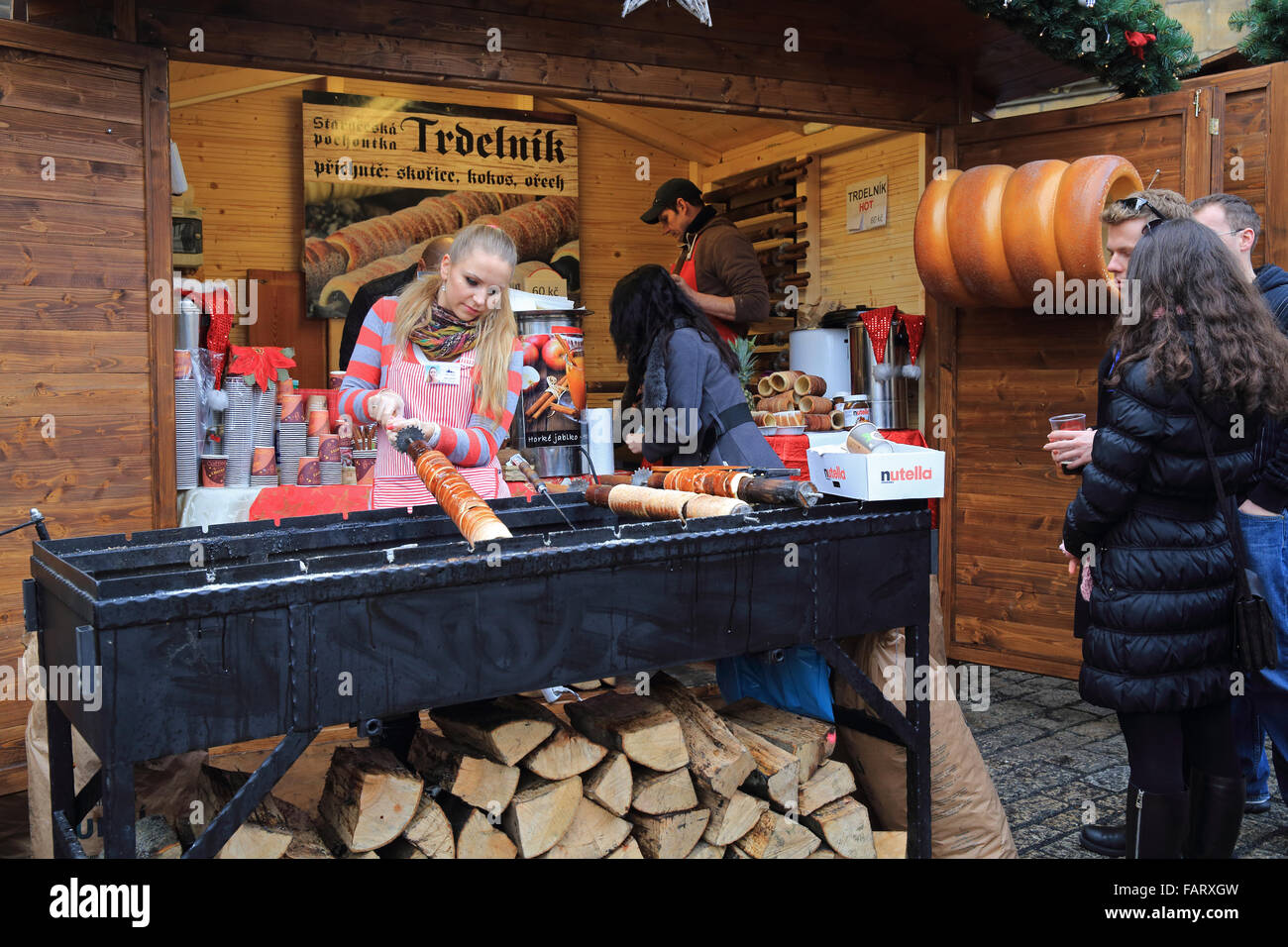 Cooking and selling 'trdelnik', the traditional Czech cake and sweet pastry on the Christmas market in Prague Castle Stock Photo