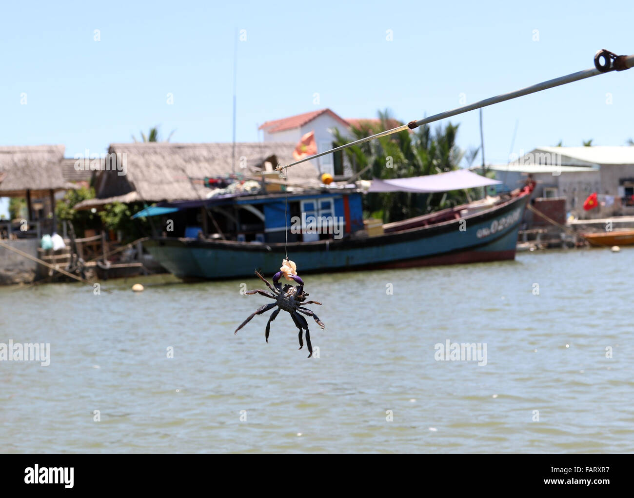 catching boat river tourist tour crab fishing rod Stock Photo