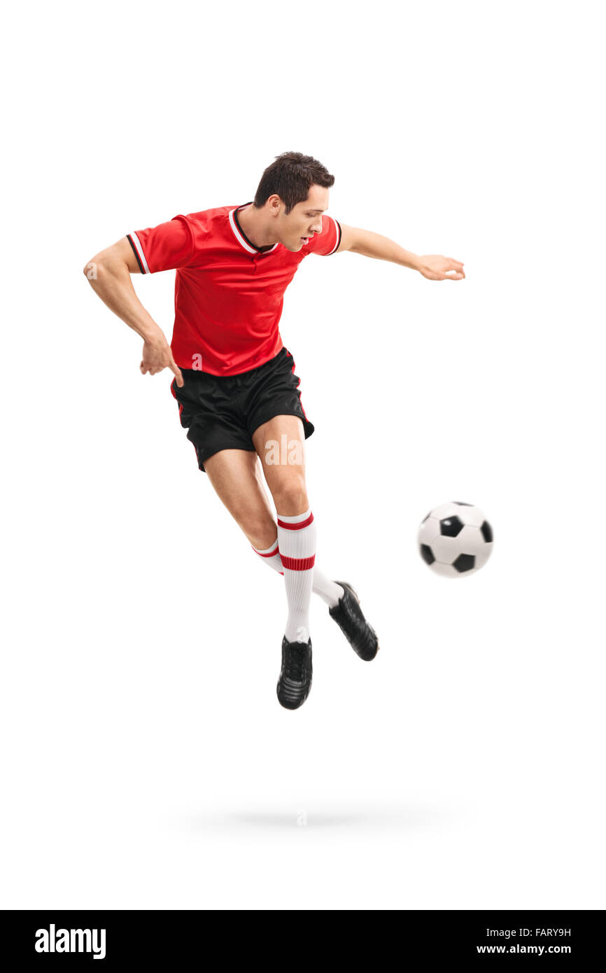 Full length portrait of a skillful football player performing a rainbow flick shot in mid-air isolated on white background Stock Photo